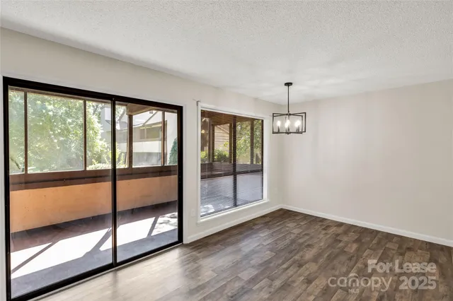 a view of an empty room with glass door