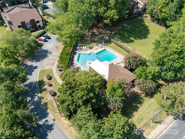 an aerial view of a house with yard