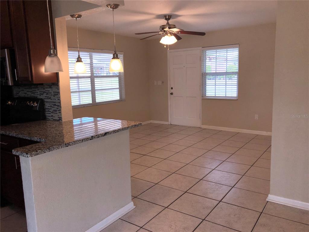 531 Springfield Street Deltona, FL 32725 - Photo 8 of 23 an empty room with windows and ceiling fan