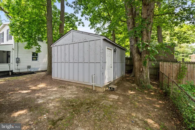 a view of backyard and small cabin
