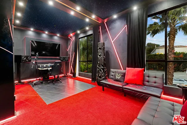 a living room with furniture a flat screen tv and floor to ceiling window
