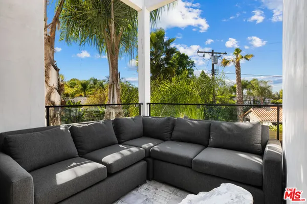 a roof deck with couch and city view