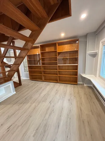 a view of an empty room and wooden floor