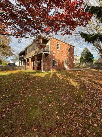 front view of a house with a large tree
