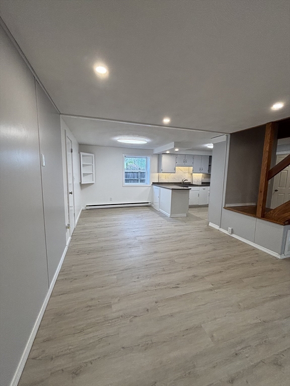 97-99 Roffee Street, Unit 1 Barrington, RI 02806 - Photo 4 of 28 a view of a big room with wooden floor and windows
