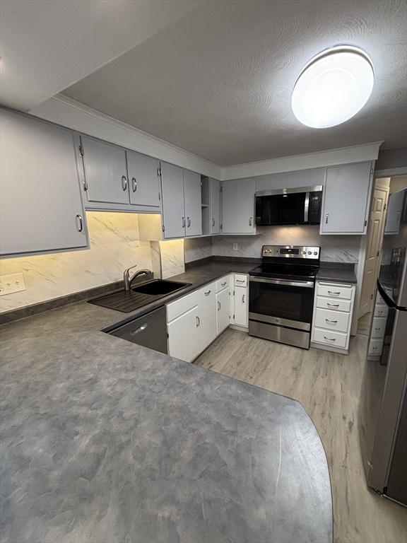 97-99 Roffee Street, Unit 1 Barrington, RI 02806 - Photo 6 of 28 a kitchen with stainless steel appliances granite countertop a stove a sink and a refrigerator
