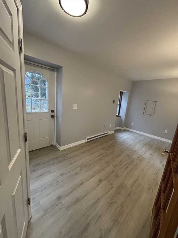 97-99 Roffee Street, Unit 1 Barrington, RI 02806 - Photo 8 of 28 an empty room with wooden floor and windows