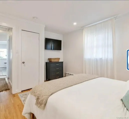 a bedroom with a bed and a television