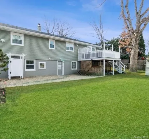 a front view of a house with a garden and trees
