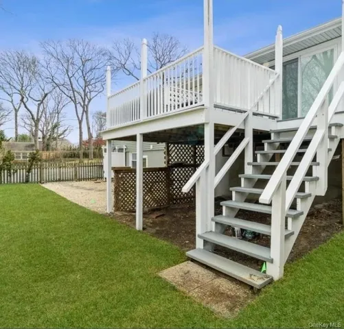 a view of a house with backyard and deck