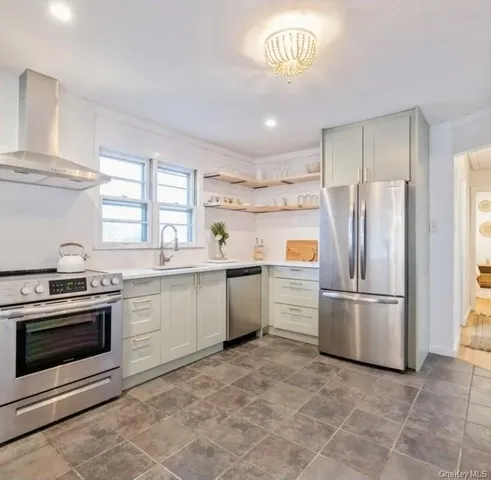 a kitchen with a stove top oven and refrigerator