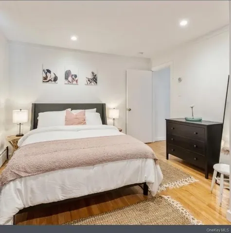 a bedroom with a bed and a night stand