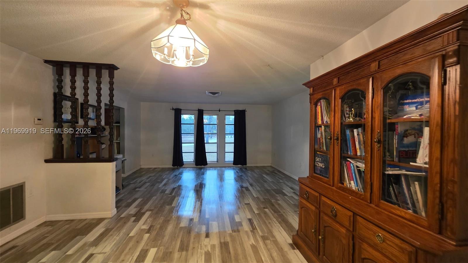 18227 Branch Road Hudson, FL 34667 - Photo 7 of 17 a view of a hallway with wooden floor and staircase