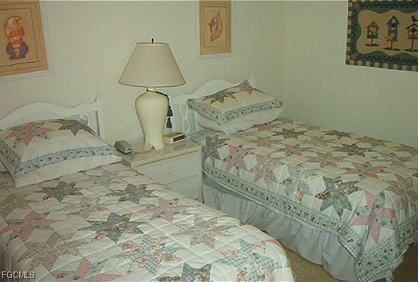 16200 Kelly Cove Drive, Unit 215 Fort Myers, FL 33908 - Photo 13 of 46 a bedroom with a bed and a window