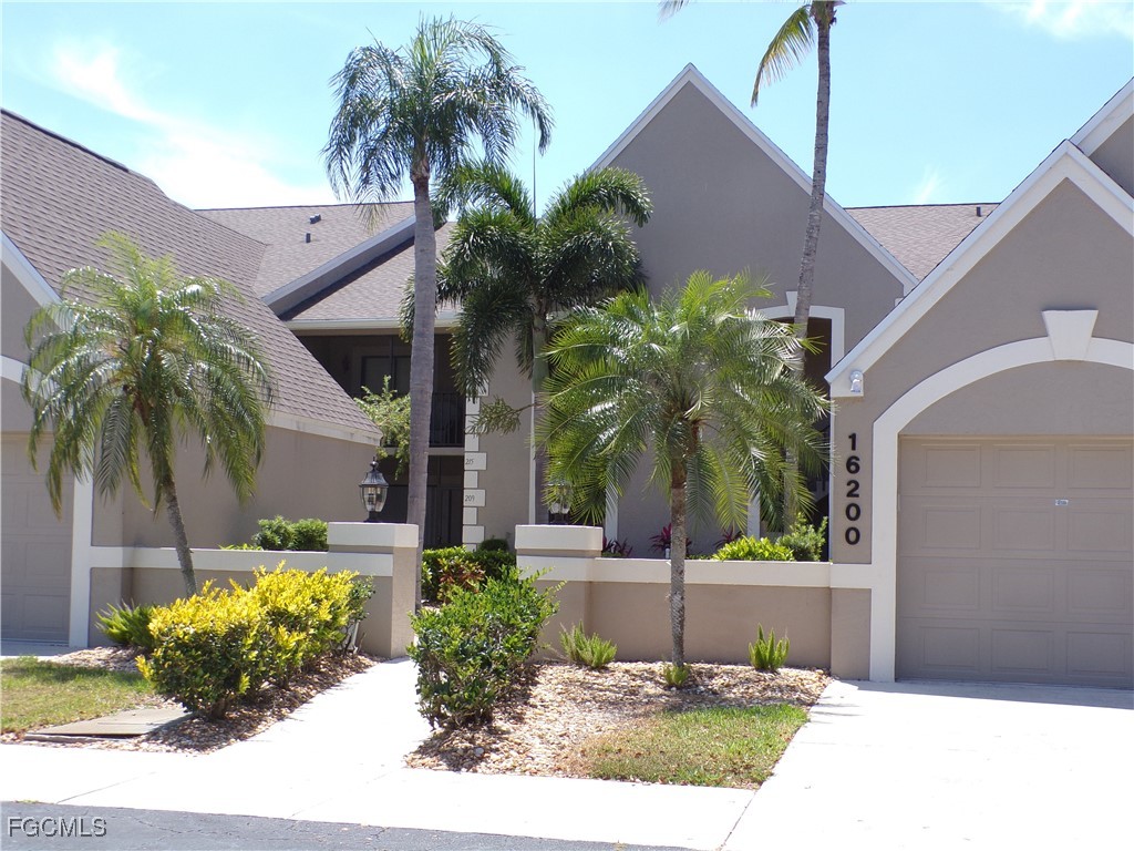 16200 Kelly Cove Drive, Unit 215 Fort Myers, FL 33908 - Photo 2 of 46 a front view of house with small garden