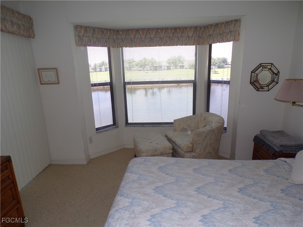16200 Kelly Cove Drive, Unit 215 Fort Myers, FL 33908 - Photo 27 of 46 a bedroom with a large bed and a window