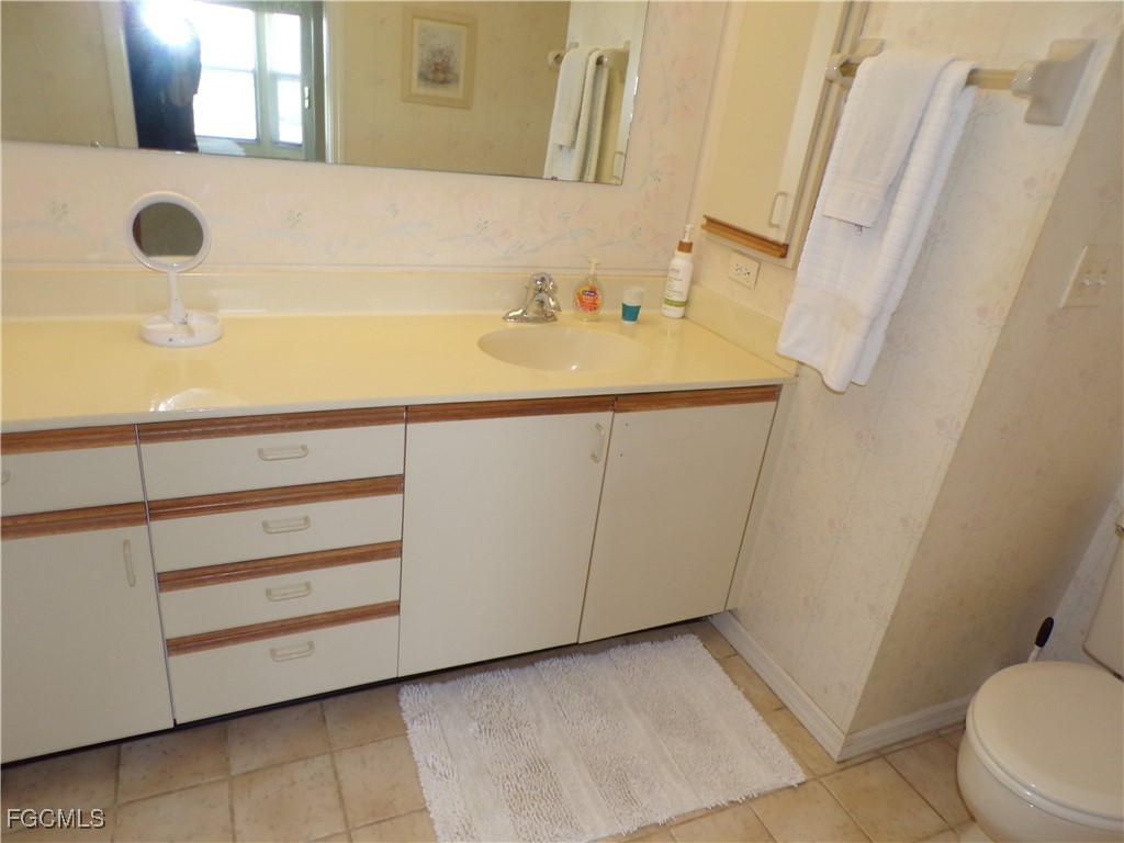 16200 Kelly Cove Drive, Unit 215 Fort Myers, FL 33908 - Photo 30 of 46 a bathroom with a sink and a mirror