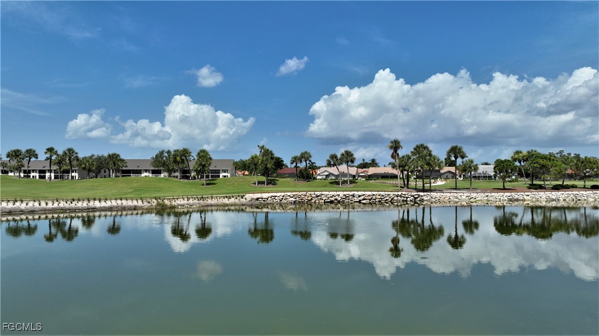 16200 Kelly Cove Drive, Unit 215 Fort Myers, FL 33908 - Photo 36 of 46 a view of a lake with houses in the back