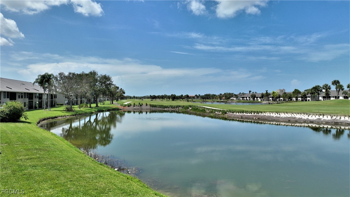 16200 Kelly Cove Drive, Unit 215 Fort Myers, FL 33908 - Photo 37 of 46 a view of a lake with houses in the back