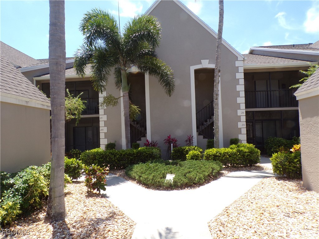 16200 Kelly Cove Drive, Unit 215 Fort Myers, FL 33908 - Photo 5 of 46 a front view of a house with a yard