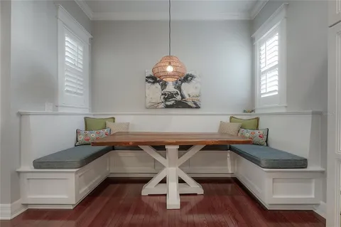 a kitchen with a sink cabinets and wooden floor