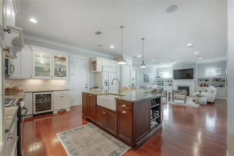 a kitchen with stove a sink and cabinets