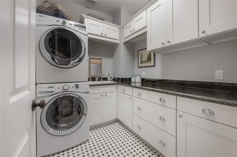 a utility room with sink dryer and washer