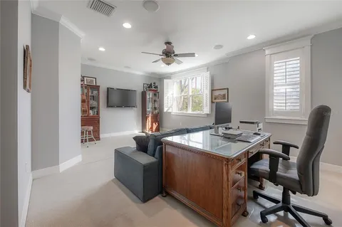 a view of a livingroom with workspace and a window