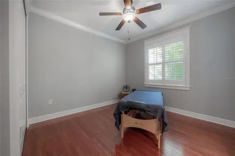 a room with wooden floor and windows