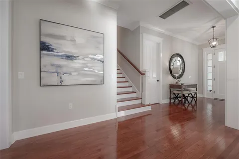 a view of a room with wooden floor and a clock