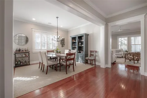 a view of a a dining room with furniture window and wooden floor