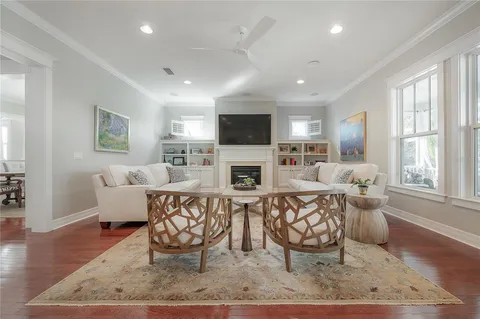 a living room with furniture a fireplace and a flat screen tv