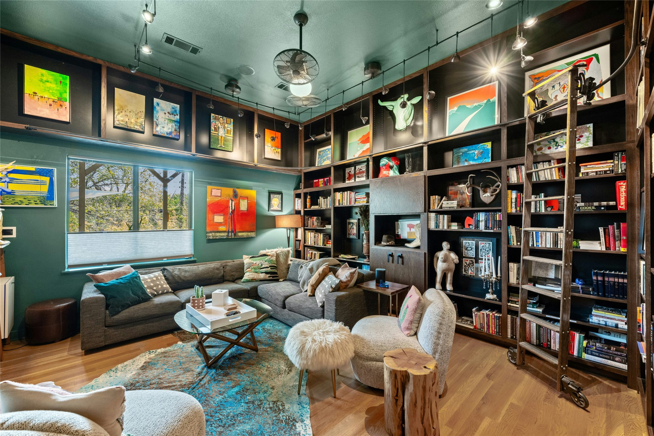 2409 East Side Drive Austin, TX 78704 - Photo 14 of 40 a living room with lots of furniture and a book shelf