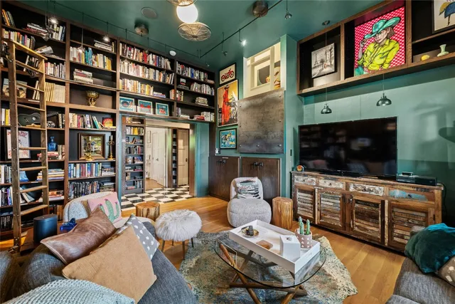 a living room with furniture a bookshelf and a book shelf