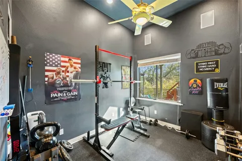 a living room with furniture a flat screen tv and a bookshelf