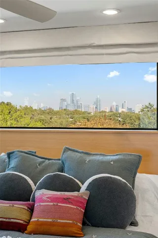 a bedroom with a large bed and a flat tv screen