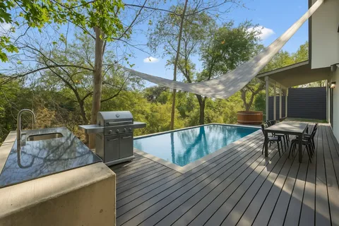 a view of a patio with couches table and chairs and potted plants