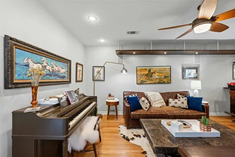 a living room with furniture and wall paintings