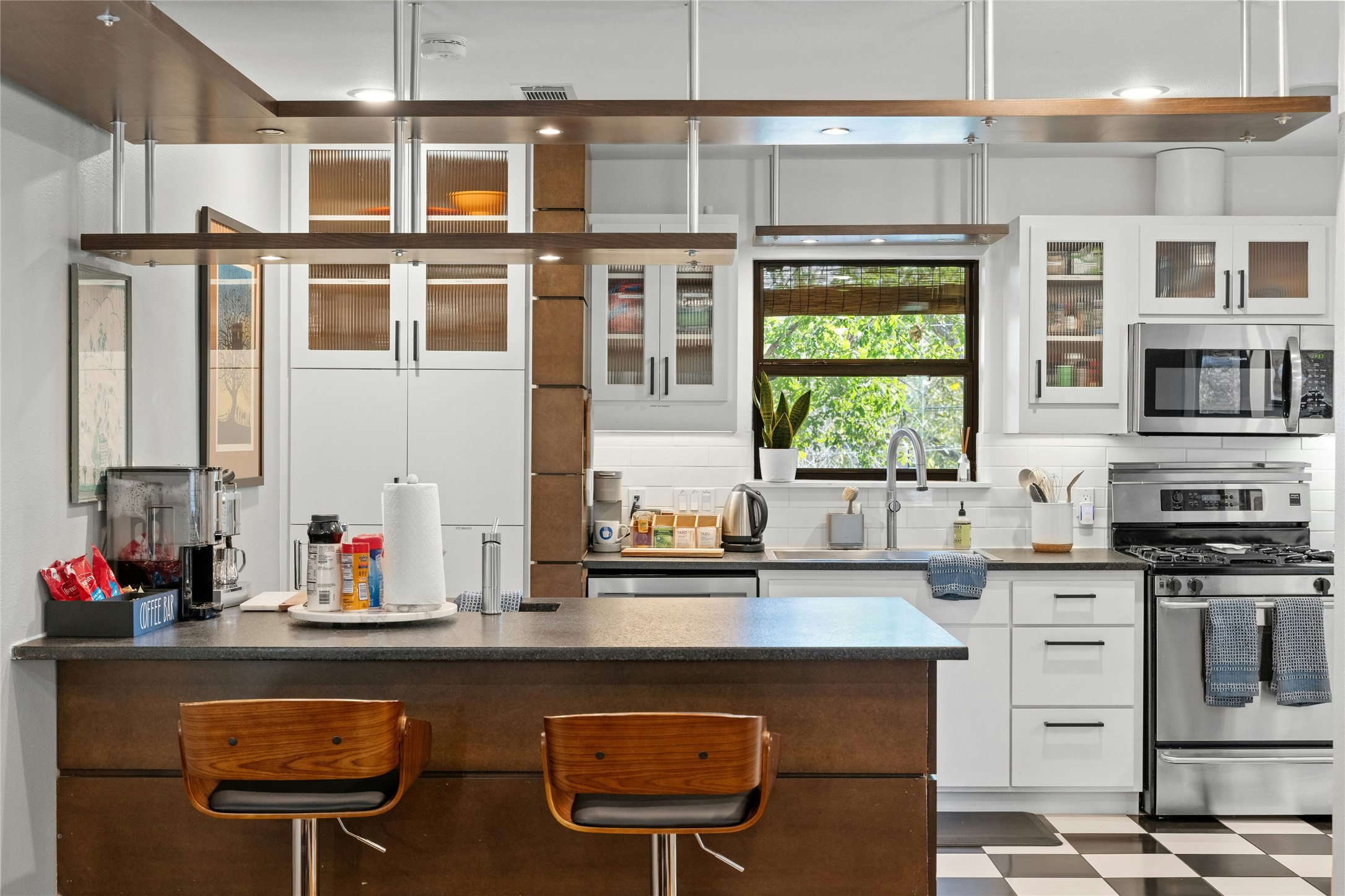 2409 East Side Drive Austin, TX 78704 - Photo 10 of 40 a kitchen with stainless steel appliances granite countertop a sink and a stove