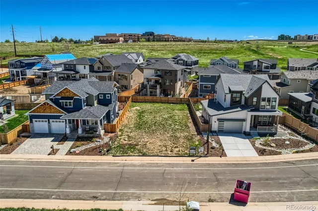 an aerial view of residential houses and outdoor space