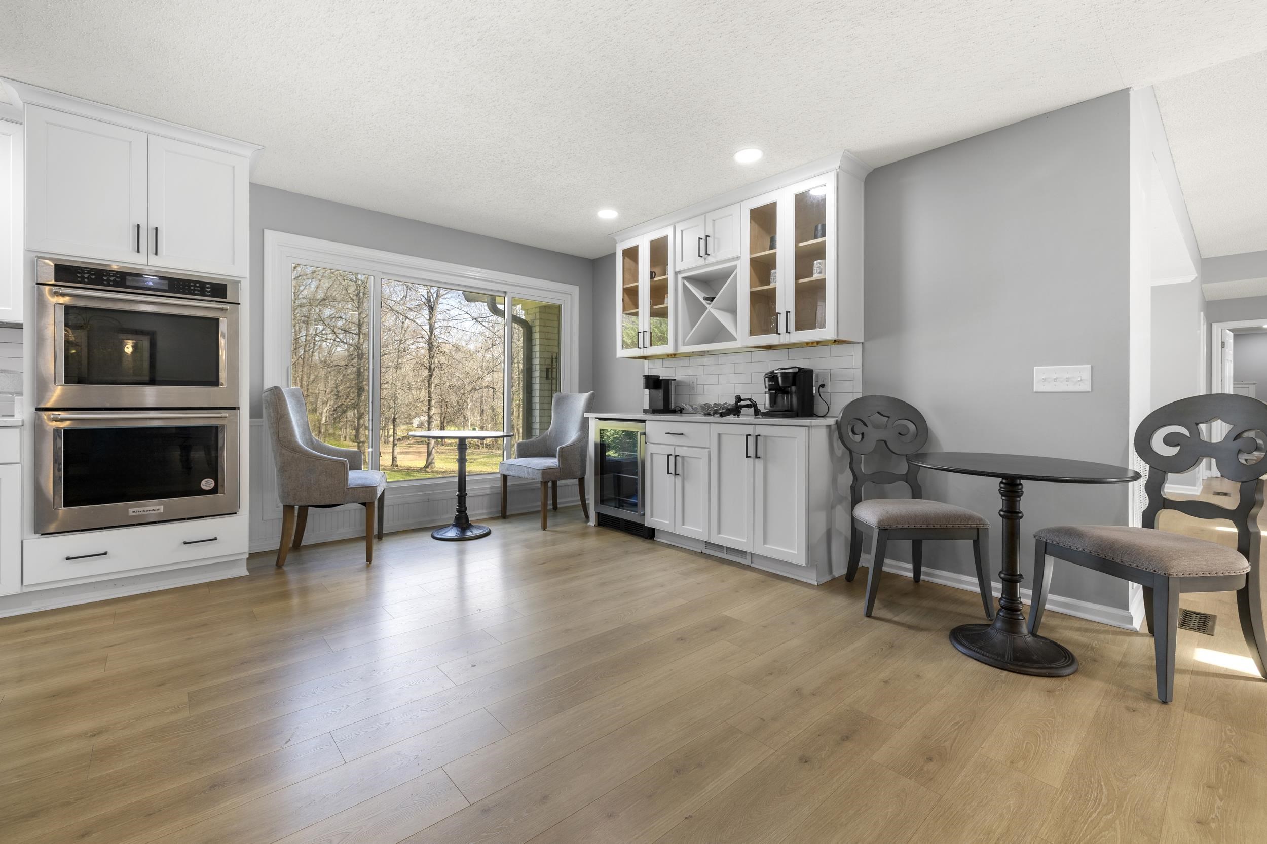 460 Woodbridge Road Somerville, TN 38068 - Photo 12 of 40 Coffee bar featuring white cabinets, glass fronted cabinets, stainless steel double oven, recessed lighting, and beverage cooler