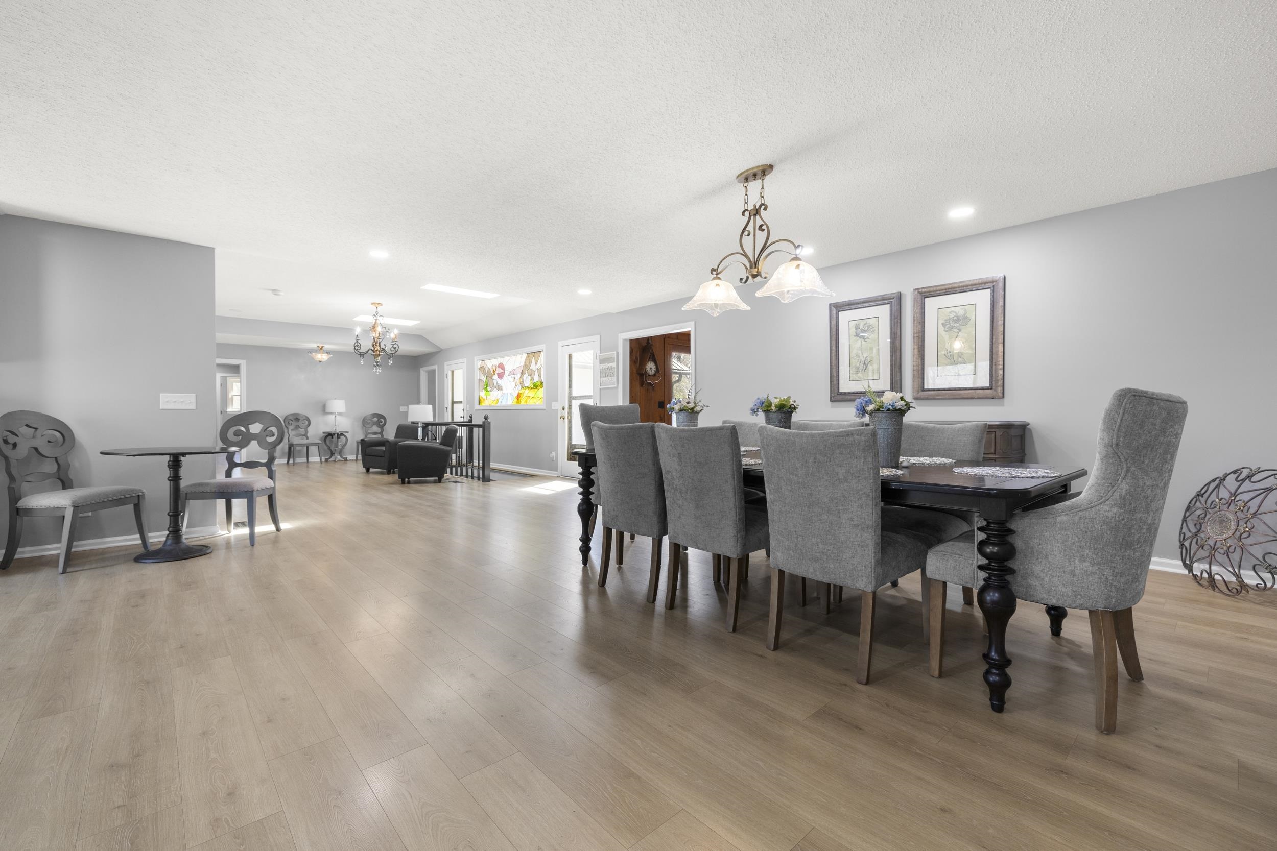 460 Woodbridge Road Somerville, TN 38068 - Photo 13 of 40 Dining area with suspended lighting, light wood-style flooring, and a textured ceiling