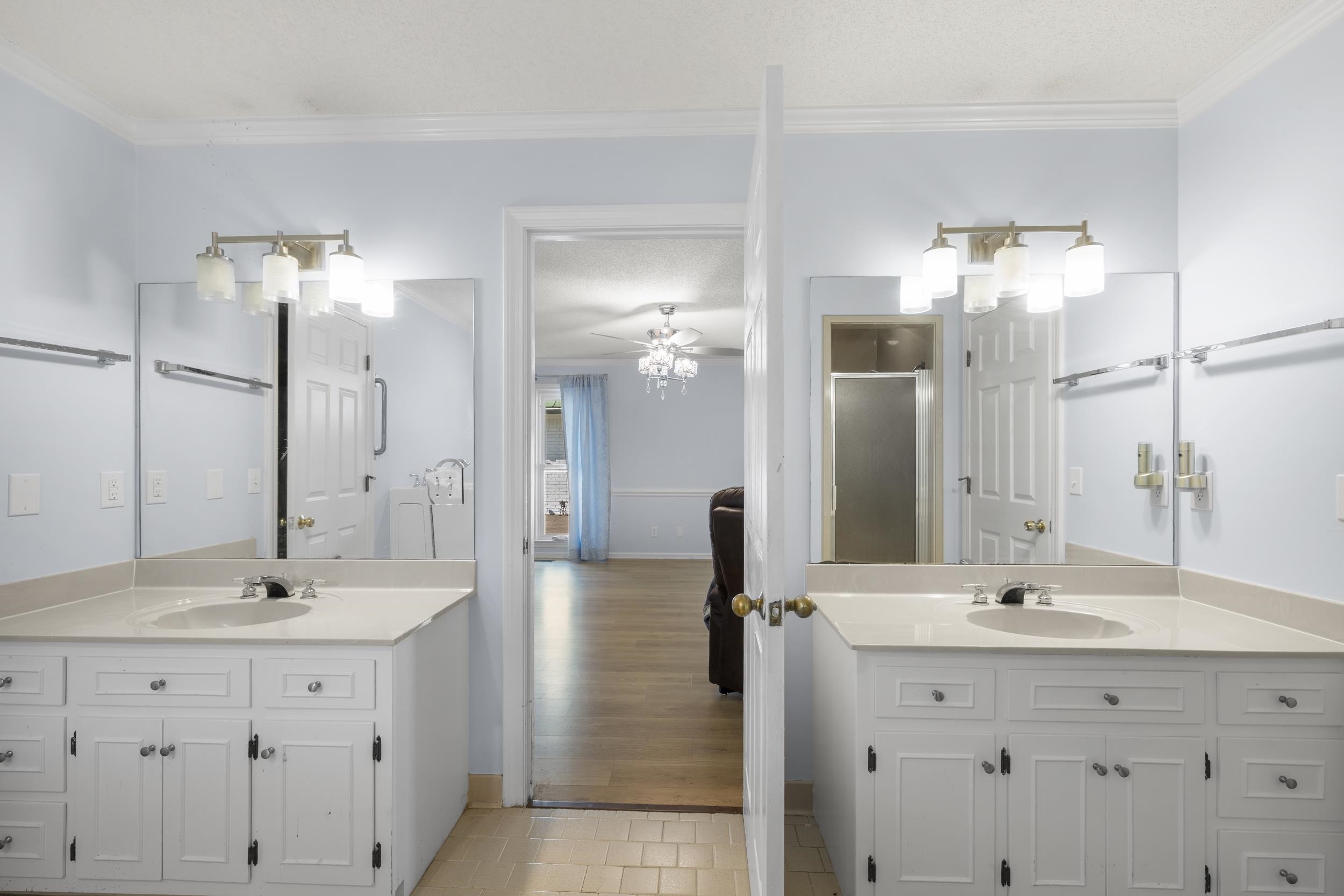 460 Woodbridge Road Somerville, TN 38068 - Photo 16 of 40 Bathroom with two vanities, ceiling fan, crown molding, a stall shower, and light tile patterned flooring