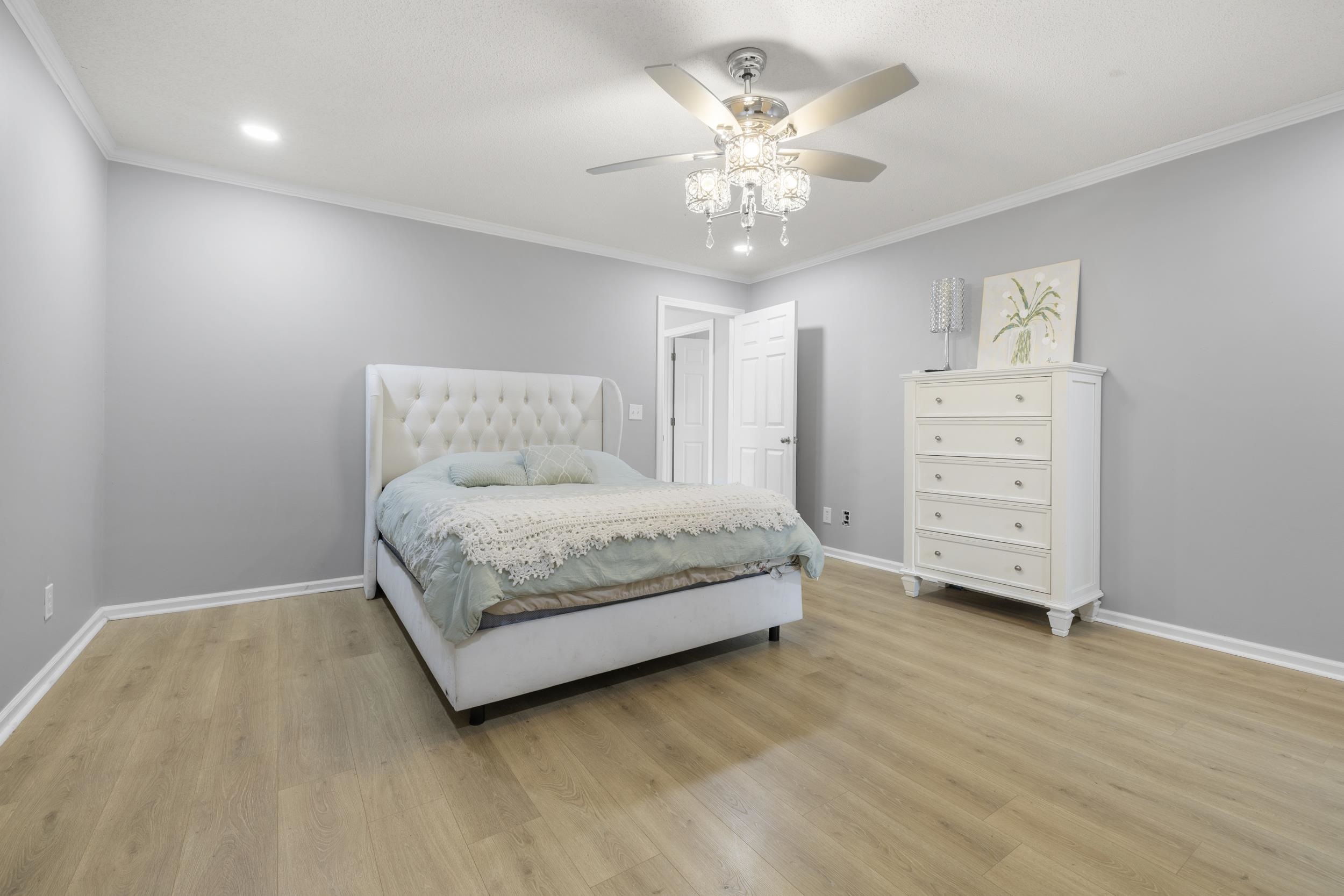 460 Woodbridge Road Somerville, TN 38068 - Photo 20 of 40 Bedroom featuring crown molding, light wood finished floors, and a ceiling fan