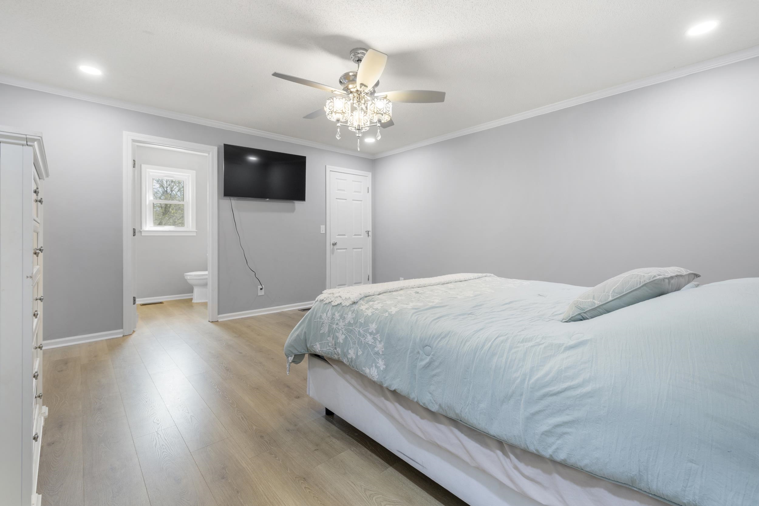 460 Woodbridge Road Somerville, TN 38068 - Photo 21 of 40 Bedroom featuring light wood-style floors, crown molding, a ceiling fan, ensuite bathroom, and recessed lighting