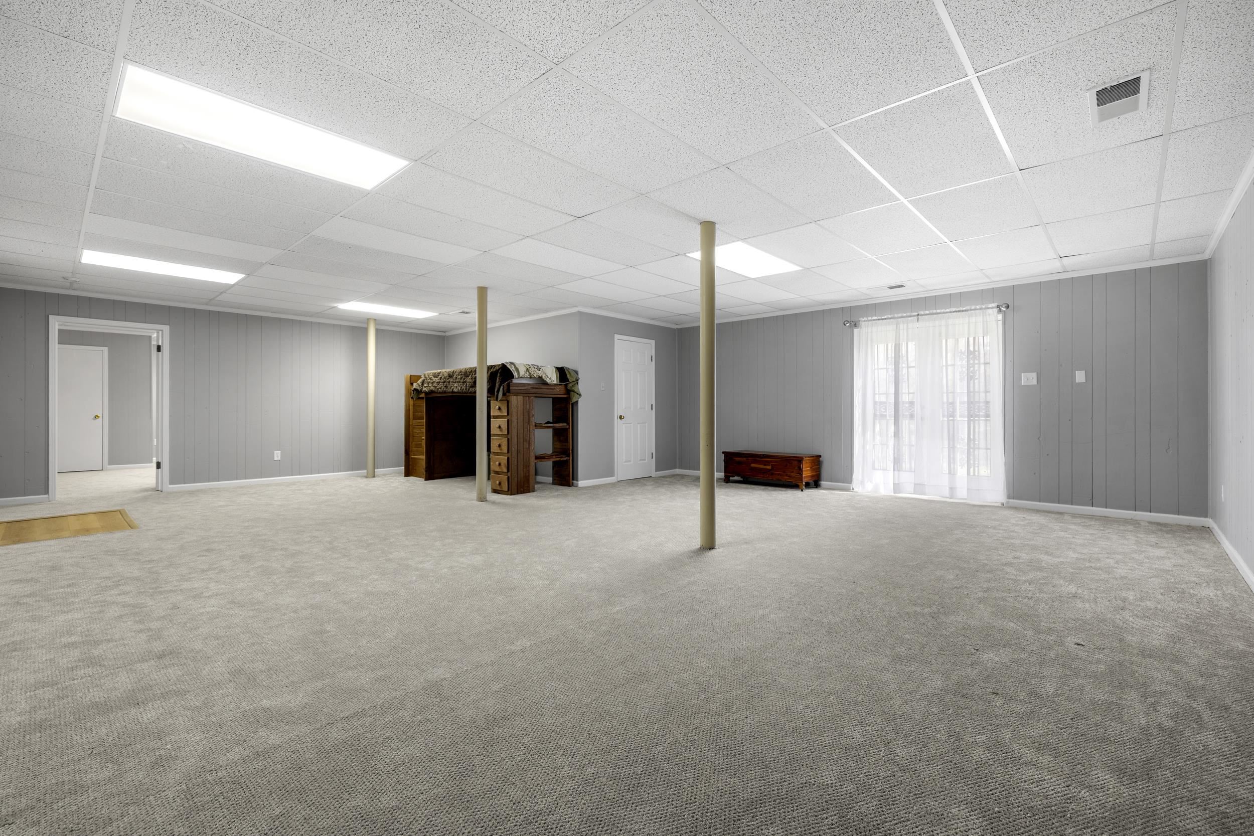 460 Woodbridge Road Somerville, TN 38068 - Photo 25 of 40 Play Room area with carpet floors, wood walls, and a paneled ceiling