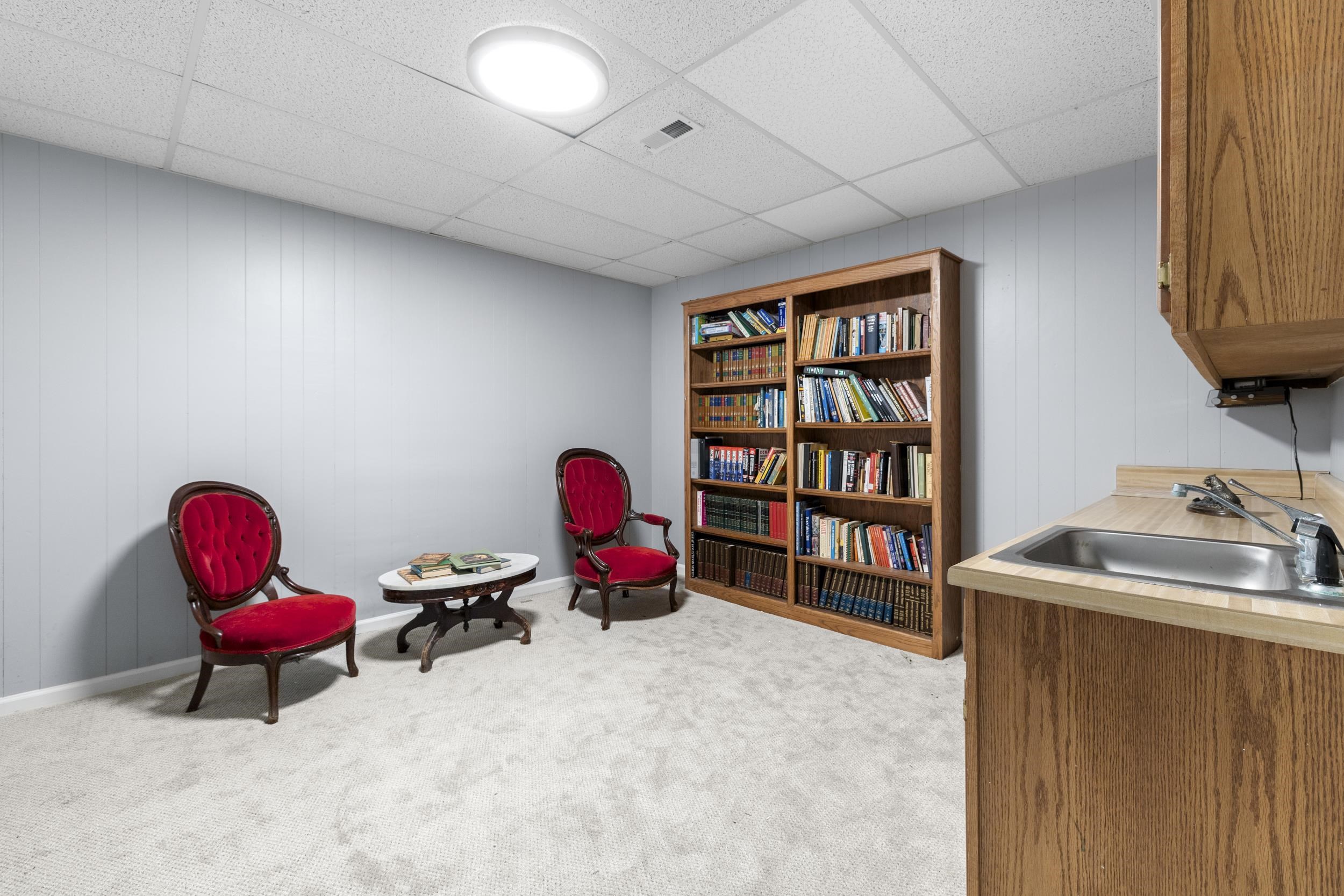 460 Woodbridge Road Somerville, TN 38068 - Photo 28 of 40 room with wooden walls, a drop ceiling, and light carpet