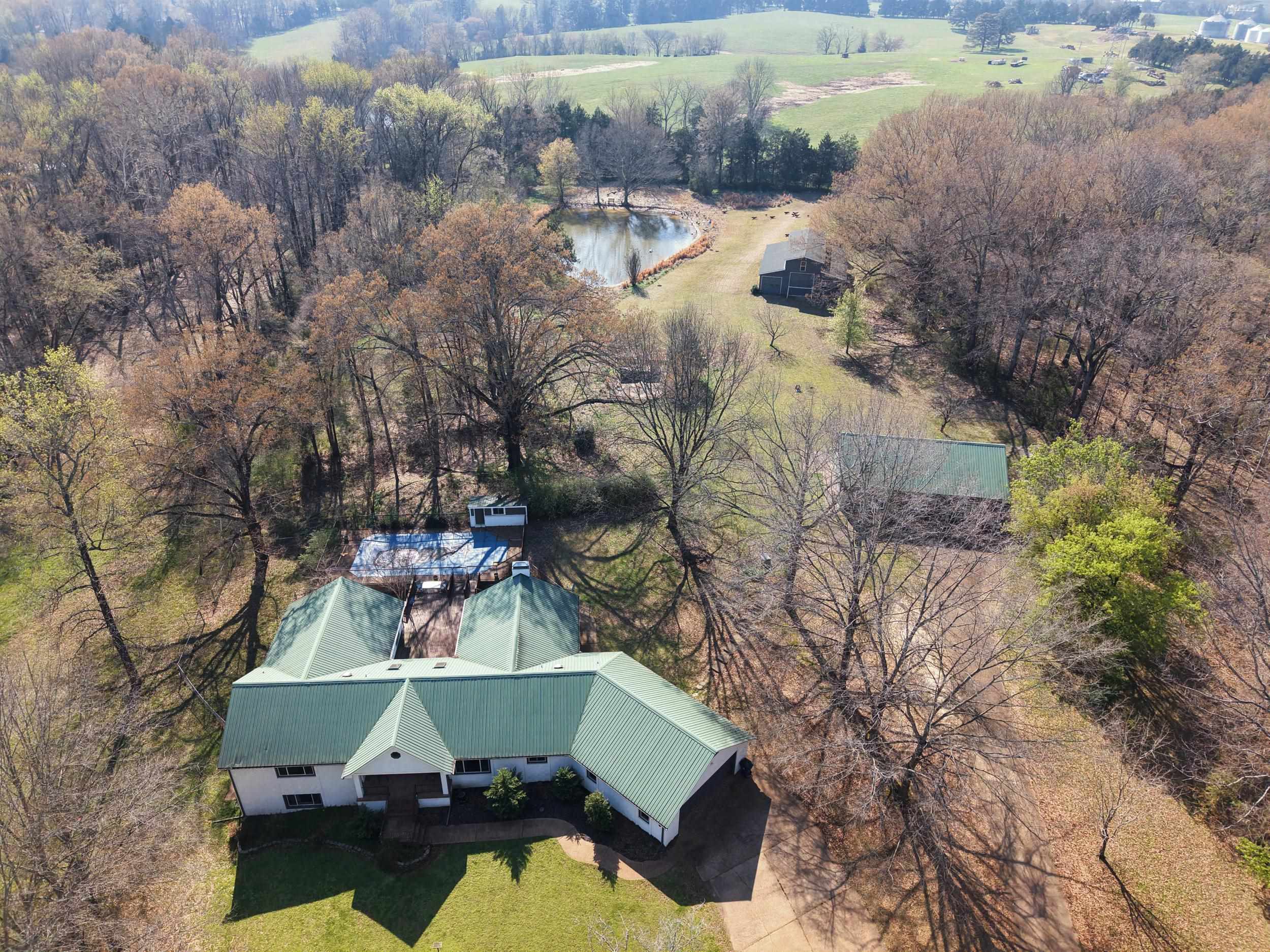 460 Woodbridge Road Somerville, TN 38068 - Photo 32 of 40 Drone / aerial view of a tree filled landscape