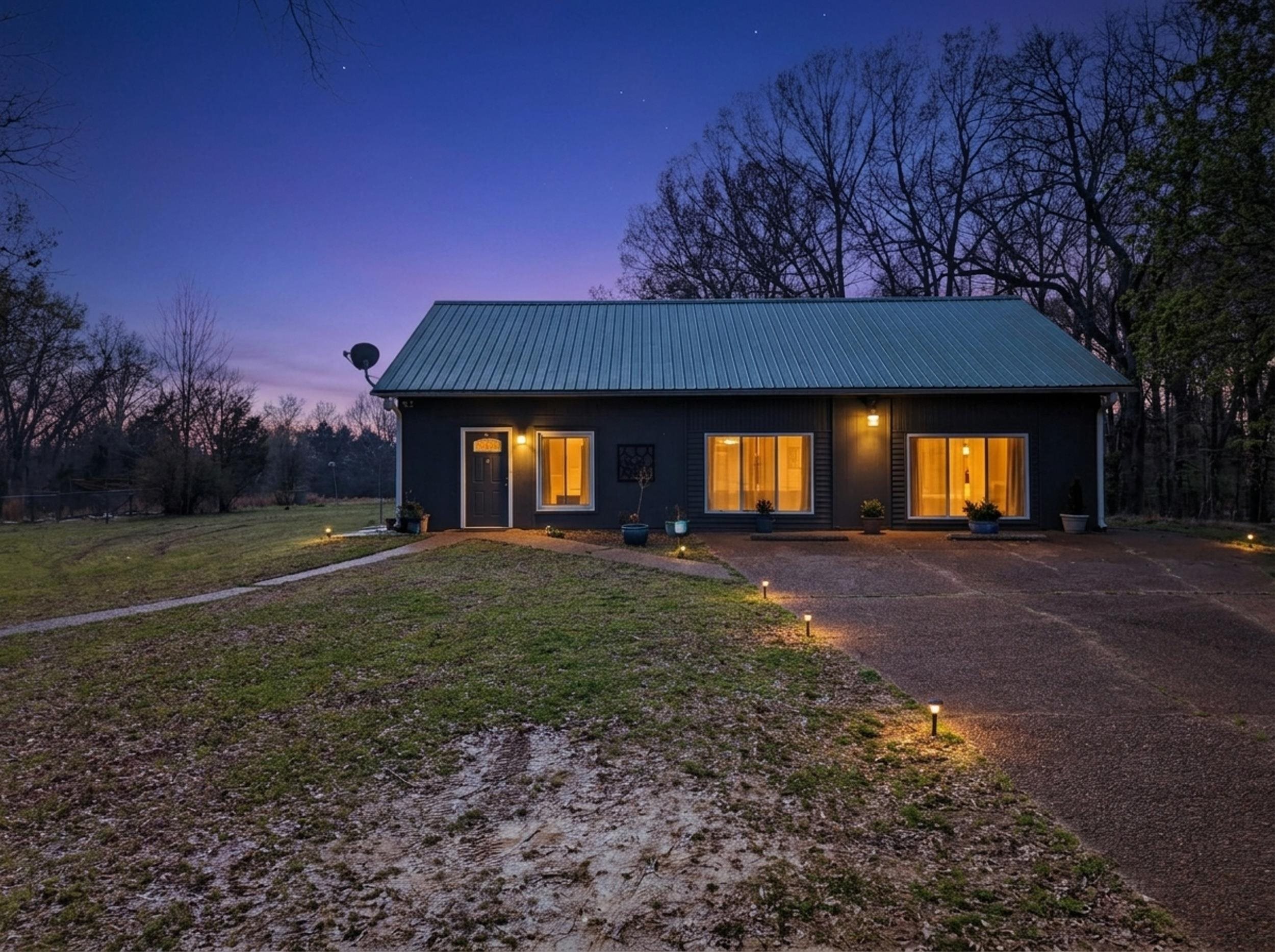 460 Woodbridge Road Somerville, TN 38068 - Photo 33 of 40 View of front of home featuring a metal roof, a lawn, covered porch, and concrete driveway