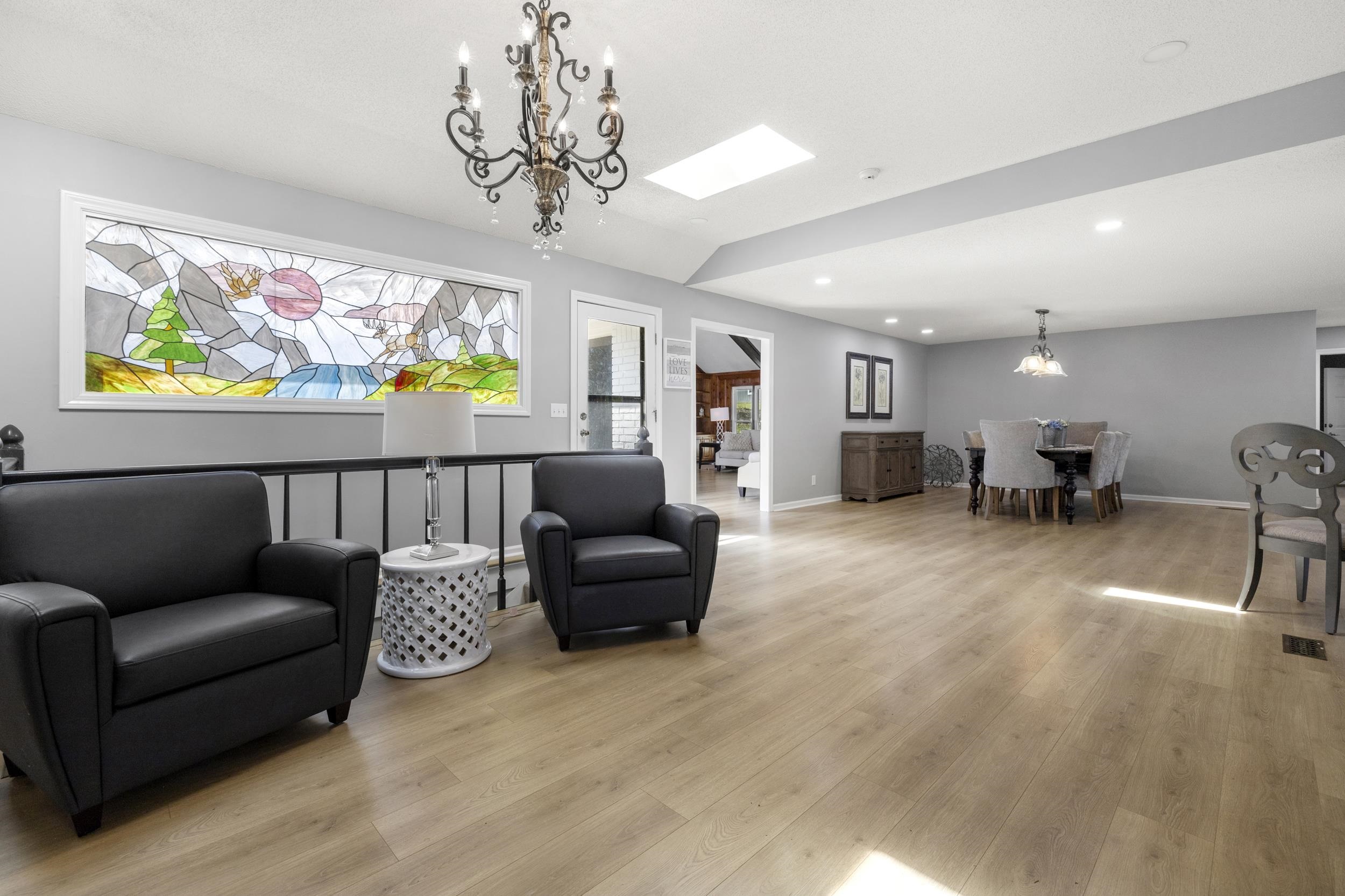 460 Woodbridge Road Somerville, TN 38068 - Photo 6 of 40 Living area featuring suspended lighting, light wood finished floors, and vaulted ceiling